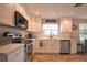 Spacious kitchen features stainless steel appliances, white cabinetry, and ample counter space for meal preparation at 200 Hummingbird Ln, Longwood, FL 32779