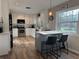 Modern kitchen with white cabinets, island with seating, stainless steel appliances, and bright lighting at 200 Hummingbird Ln, Longwood, FL 32779