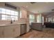 Bright kitchen with white cabinetry, stainless steel appliances, and a view to the living area through an open floor plan at 200 Hummingbird Ln, Longwood, FL 32779