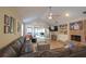 View of the spacious living room with vaulted ceilings, hardwood floors, and a brick fireplace at 200 Hummingbird Ln, Longwood, FL 32779