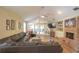 Bright living room with wood flooring, vaulted ceiling, and a cozy brick fireplace at 200 Hummingbird Ln, Longwood, FL 32779