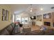 Spacious living room featuring wood flooring, a brick fireplace, and access to the screened patio at 200 Hummingbird Ln, Longwood, FL 32779