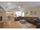 Open-concept living room featuring a large sectional sofa, fireplace, and views to the kitchen and dining area at 200 Hummingbird Ln, Longwood, FL 32779