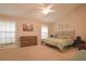 Spacious main bedroom with neutral carpet, vaulted ceiling, and a comfortable bed with two windows at 200 Hummingbird Ln, Longwood, FL 32779