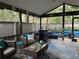 Inviting screened patio featuring comfortable seating areas and a ceiling fan at 200 Hummingbird Ln, Longwood, FL 32779