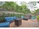 Outdoor patio featuring comfortable seating, a fire pit, and lush landscaping at 200 Hummingbird Ln, Longwood, FL 32779
