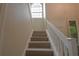 Bright staircase with carpet, complemented by a white railing and a decorative window at 200 Hummingbird Ln, Longwood, FL 32779