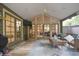 Inviting sunroom with vaulted ceilings, wicker furniture, and lots of windows at 200 Hummingbird Ln, Longwood, FL 32779