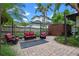 Relaxing backyard setting with cozy furniture and privacy fence creating an intimate outdoor living space at 2190 Temple Dr, Winter Park, FL 32789