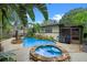 The beautiful backyard features a gorgeous in-ground pool, hot tub, built-in grill, and patio at 2190 Temple Dr, Winter Park, FL 32789