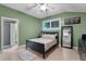 A green bedroom features a window with blinds and easy access to the bathroom and the kitchen at 2190 Temple Dr, Winter Park, FL 32789