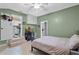 Cozy bedroom with green walls, a ceiling fan, and views into the kitchen and bathroom at 2190 Temple Dr, Winter Park, FL 32789