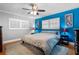 Bright bedroom featuring a ceiling fan, shuttered windows, and hardwood floors for a serene retreat at 2190 Temple Dr, Winter Park, FL 32789