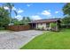 Charming home featuring a brick driveway, manicured lawn, and a privacy fence at 2190 Temple Dr, Winter Park, FL 32789