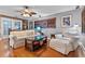 Cozy living room featuring hardwood floors, a ceiling fan, and a comfortable seating area at 2190 Temple Dr, Winter Park, FL 32789