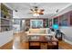 Comfortable living room boasts hardwood floors, shiplap accent wall, and bright, natural light at 2190 Temple Dr, Winter Park, FL 32789