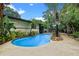 Backyard swimming pool surrounded by lush tropical landscaping offers a private outdoor retreat at 2190 Temple Dr, Winter Park, FL 32789