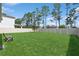 Lush green backyard featuring a well-maintained lawn and a wooden fence at 2279 Mountain Pine St, Ocoee, FL 34761