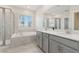 Bright bathroom featuring double vanity, soaking tub, and separate glass shower at 2279 Mountain Pine St, Ocoee, FL 34761