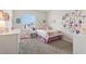 Cozy bedroom with colorful decor, plush carpet, and a bright window at 2279 Mountain Pine St, Ocoee, FL 34761