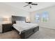 Spacious bedroom featuring a dark wood bed frame, plush carpet, and two windows at 2279 Mountain Pine St, Ocoee, FL 34761