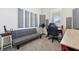 A bedroom equipped with soundproofing features a comfortable futon and a functional desk area at 2279 Mountain Pine St, Ocoee, FL 34761