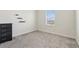 Neutral carpeted bedroom with a chest of drawers and natural light from the window at 2279 Mountain Pine St, Ocoee, FL 34761