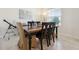 Features a wooden dining table with black chairs and a telescope in a sunlit space at 2279 Mountain Pine St, Ocoee, FL 34761