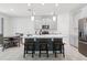 Open-concept kitchen features gray cabinets, a spacious island with seating, and stainless steel appliances at 2279 Mountain Pine St, Ocoee, FL 34761