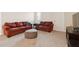 Cozy living room featuring comfortable couches and an ottoman, perfect for relaxing and entertaining at 2279 Mountain Pine St, Ocoee, FL 34761