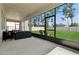Screened patio area with wicker furniture and a view of the green backyard at 2279 Mountain Pine St, Ocoee, FL 34761