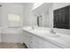 Bright bathroom featuring double sinks, garden tub, and separate toilet area at 2308 Donegan Pl, Orlando, FL 32826