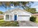 Charming single-story home with a bright blue door and well-maintained front yard at 2308 Donegan Pl, Orlando, FL 32826