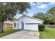 Inviting single-Gathering home with a two-car garage, blue door, and well-maintained lawn at 2308 Donegan Pl, Orlando, FL 32826