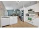 Modern kitchen with white cabinets and stainless steel appliances, seamlessly connected to the living area at 2308 Donegan Pl, Orlando, FL 32826
