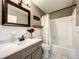 This bathroom features a vanity, framed mirror, and shower/tub combo at 249 Spartan Dr, Maitland, FL 32751