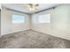 This cozy bedroom features two windows for natural light, and neutral carpeting at 249 Spartan Dr, Maitland, FL 32751
