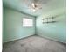 This bedroom features a ceiling fan, open shelving, and neutral carpeting at 249 Spartan Dr, Maitland, FL 32751