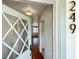 Bright foyer with hardwood floors, starburst light fixture, and view of the living area at 249 Spartan Dr, Maitland, FL 32751