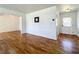 Hallway featuring hardwood floors, neutral paint, and decorative lighting at 249 Spartan Dr, Maitland, FL 32751