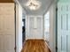 Hallway featuring wood floors, with multiple access doors at 249 Spartan Dr, Maitland, FL 32751