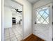 Hallway with tile flooring and view into the kitchen, featuring stainless steel appliances at 249 Spartan Dr, Maitland, FL 32751