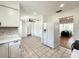 Open kitchen boasts tile floors, white appliances and cabinets, and easy access to living spaces at 249 Spartan Dr, Maitland, FL 32751