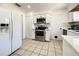 Modern kitchen with white cabinets, stainless steel appliances, and tile backsplash at 249 Spartan Dr, Maitland, FL 32751