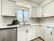 Well-lit kitchen with white cabinets, quartz countertops, and stainless steel dishwasher at 249 Spartan Dr, Maitland, FL 32751