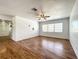 This living room features hardwood flooring, natural light, and a ceiling fan at 249 Spartan Dr, Maitland, FL 32751