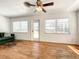 Bright living room features hardwood floors, neutral paint, and access to the backyard at 249 Spartan Dr, Maitland, FL 32751