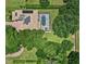 Aerial view of a home with solar panels and screened-in pool surrounded by lush greenery at 25537 High Hampton Cir, Sorrento, FL 32776