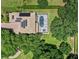 Aerial view of home with solar panels and screened-in pool surrounded by trees at 25537 High Hampton Cir, Sorrento, FL 32776