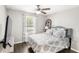 Bright bedroom with a large window, stylish ceiling fan, and a comfortable bed at 25537 High Hampton Cir, Sorrento, FL 32776